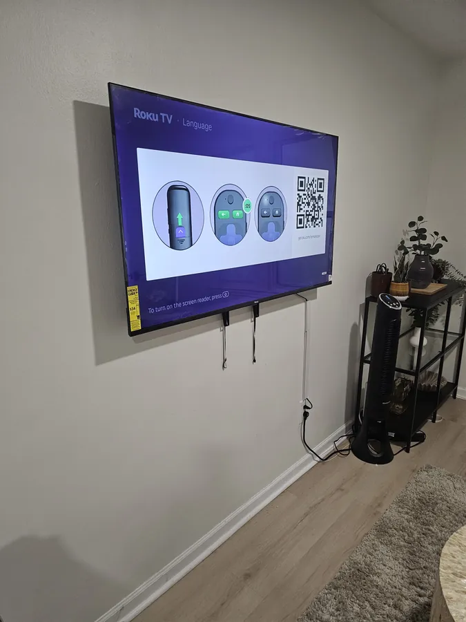 Flat-screen television mounted on a wall with the cables run out of sight