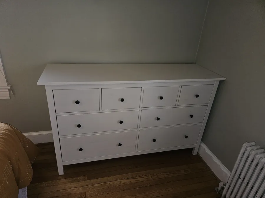Assembled eight-drawer dresser standing level against a bedroom wall