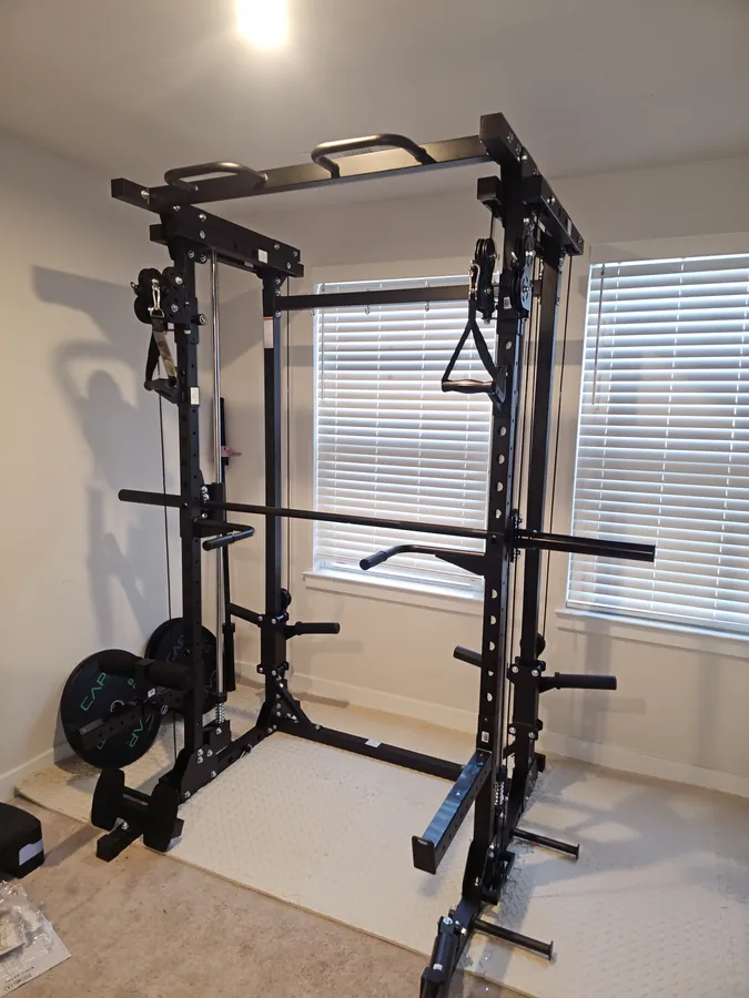 Home gym squat rack assembled and set up in a spare room