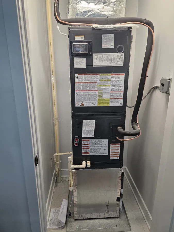 Air handler installed in a utility space with new line set and drain piping